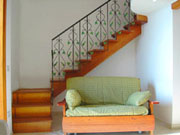Amalfi Coast Accommodation: Sofa-bed and the staircase which takes to the mezzanine level with the double bed of Ludovica Accommodation Type D along the Amalfi Coast